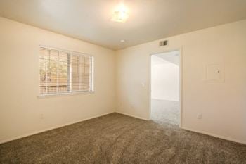 an empty room with a window and a door